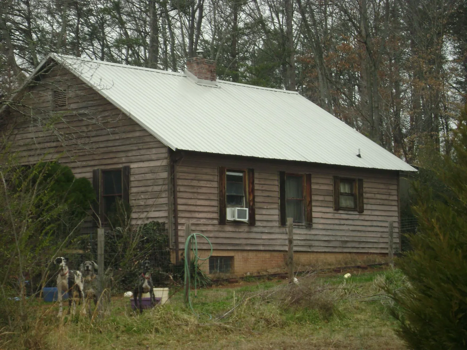 White metal roof on an old wood sided farmhouse, from a Metal Roof Installation job in Wampum